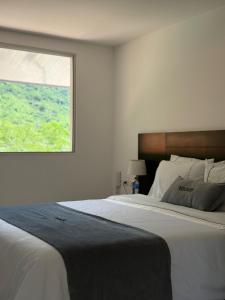 Voodi või voodid majutusasutuse Malokas Resort - Socorro - San Gil toas