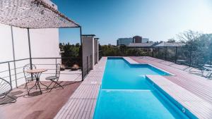 a swimming pool with a table and chairs on a deck at Pilar Suites by Viva in Pilar