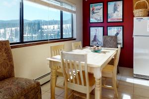 a kitchen with a table and chairs and a refrigerator at Buffalo Ridge 205 in Silverthorne