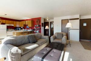 a living room with two couches and a kitchen at Buffalo Ridge 205 in Silverthorne +32 photos