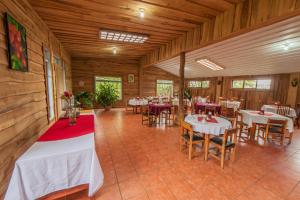 a restaurant with tables and chairs in a room at Hotel Claro de Luna in Monteverde Costa Rica
