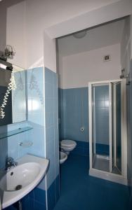 a bathroom with two toilets and a sink and a shower at Residence Avana in Senigallia