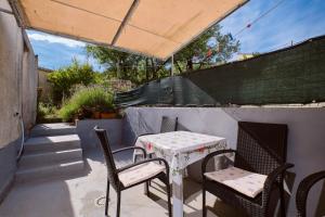 a table and chairs sitting on a patio at Mario in Martinšćica