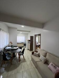 a living room with a couch and a table at Noel Rosa Building in Foz do Iguaçu