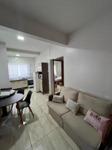 a living room with a couch and a table at Noel Rosa Building in Foz do Iguaçu
