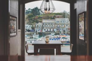 a room with a table and a view of a marina at The Old Custom House in Padstow