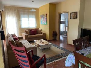 a living room with a couch and a table at Apartments Villa Braho in Pogradec