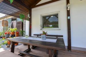 a wooden picnic table sitting on a patio at Apartman Katja in Rakovica