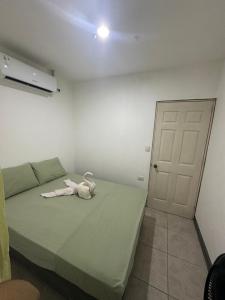 a bedroom with a bed with a white towel on it at Apartamento KERU in San Juan del Sur +10 photos
