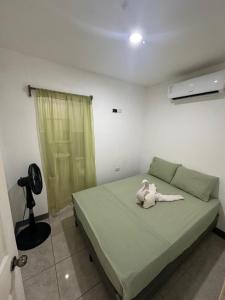 a bedroom with a bed with a stuffed animal on it at Apartamento KERU in San Juan del Sur