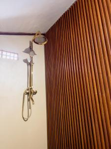 a shower head in a bathroom next to a curtain at KA MANIcamp in Angsri +45 photos