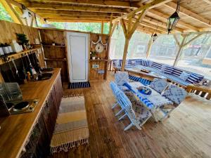a kitchen and living room with a table and chairs at Каравана Coco Bongo in Chernomorets