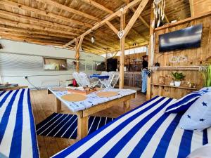 a living room with a table and a tv at Каравана Coco Bongo in Chernomorets