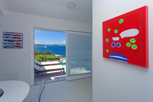 a living room with a red painting on the wall at Blue Bay Residence in Hvar
