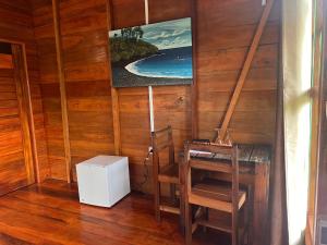 a corner of a room with a table and a chair at Casa Cantagalo - Guest House & Bar Restaurant in SantʼAna
