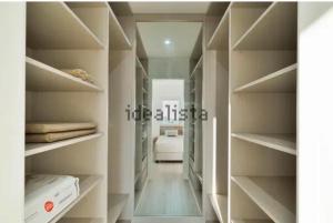 a hallway with shelves and a bed in a room at FM Marina Vilamoura in Quarteira