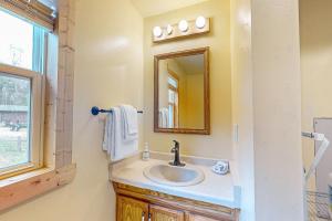 a bathroom with a sink and a mirror at The View on Found Lake in Saint Germain