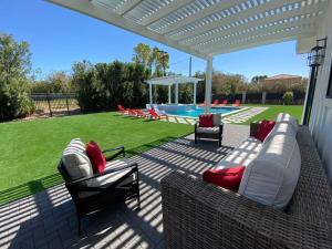a patio with couches and chairs and a pool at The Phoenix Farmhouse in Phoenix