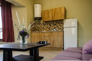 a kitchen with a table and a white refrigerator at Sevan - Artanish Beach Resort in Artanish
