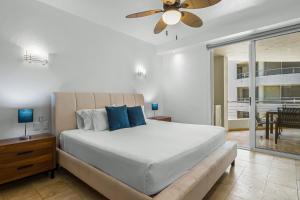 a bedroom with a bed and a ceiling fan at Nitta Condo 109 in Nuevo Vallarta  +34 photos