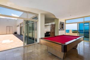 a pool table in a room with a view of the ocean at Nitta Condo 109 in Nuevo Vallarta 