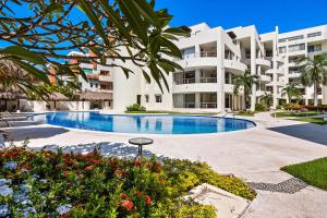 a large apartment building with a swimming pool at Nitta Condo 109 in Nuevo Vallarta 