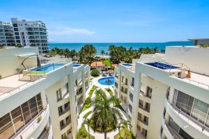 an aerial view of two buildings with the ocean in the background at Nitta Condo 109 in Nuevo Vallarta 