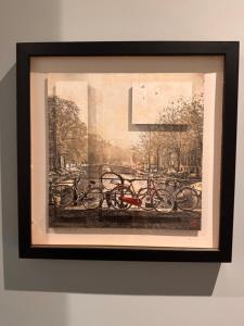 a framed picture of bikes parked in a park at Décor Canal House in Amsterdam