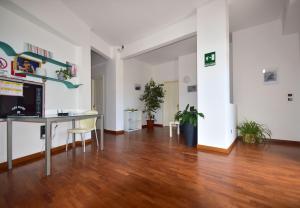 a living room with a desk and a table at Residence Avana in Senigallia