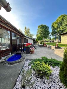 a yard with a house with a blue pond at Pool House in Subotica