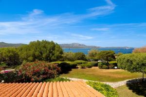 a view of a garden with a view of the water at Porto Rotondo Bay View in Porto Rotondo