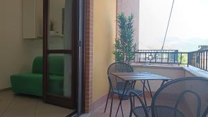 a balcony with a table and chairs and a window at Trekking House B&B-Vicino al Tribunale di Nocera Inferiore - in Nocera Inferiore +13 photos