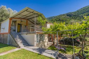 a house with a car parked in front of it at Mijailovic apartmani PARKING WI FI AIR CONDITION FREE in Kaluđerac