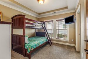 a bedroom with two bunk beds and a flat screen tv at CSC2R - Dolphins Den in Kill Devil Hills +53 photos