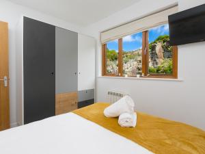 Un dormitorio con una cama grande con ventana. en Branock, Tor Down Quarry, en Bodmin
