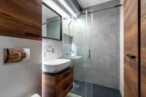 a bathroom with a sink and a glass shower at Stablewskiego Poznań Spot in Poznań +19 photos