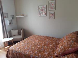 a bedroom with a bed and a chair at Buxerioux Retreat in Châteauroux
