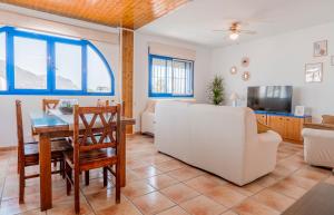 a living room with a white couch and a table at Casa Dracaena in San José