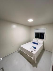 ein weißes Zimmer mit einem Bett mit einem Fenster in der Unterkunft Condomínio Alto da Serra Negra in Bezerros + 11 Fotos