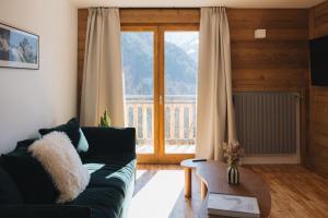 a living room with a couch and a large window at Chalet Flachaire in Abondance