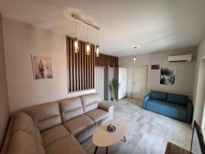a living room with a couch and a table at Tamape apartment in Katun