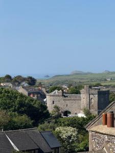 a view of a town with a castle at St Davids Art House in St. Davids