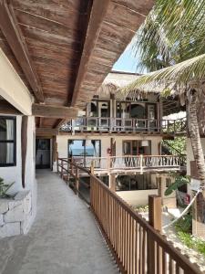 a balcony of a resort with a wooden ceiling at Chica in Tulum