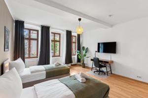 ein Hotelzimmer mit zwei Betten und einem Schreibtisch in der Unterkunft KERA STAY - Apartments Merseburg in Merseburg