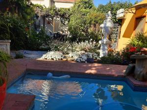 a swimming pool with a fountain in a yard at Cathys Guesthouse 1 in Cradock
