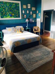 a bedroom with a large bed and a blue wall at Le Petit Couvent in LʼIsle-en-Dodon +37 photos