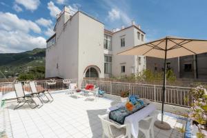 维克艾库塞Marisabella luxury home的一座带遮阳伞和椅子的庭院和一座建筑