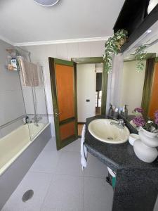 a bathroom with a sink and a toilet and a tub at Villa Eiros in Belandres