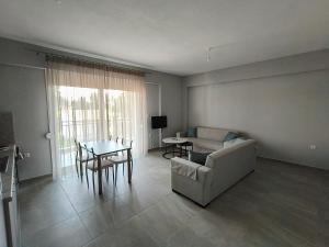 a living room with a couch and a table at Irina's Apartment 3 in Psakoudia