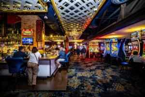 people sitting at a bar in a casino at Downtown Grand Hotel & Casino in Las Vegas